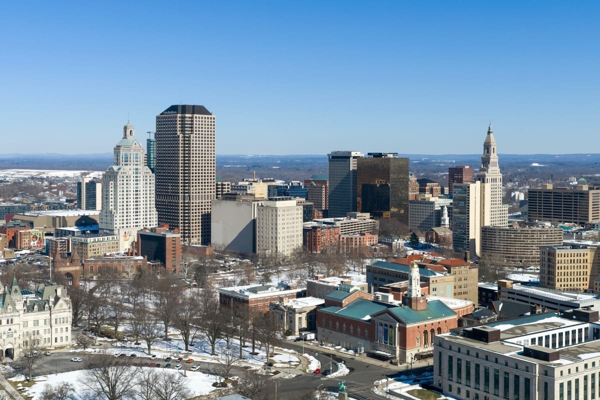 A winter view over rooftops toward a cluster of downtown towers