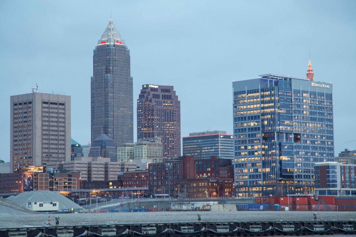 A lakefront skyline, one tall tower with a pointed top above the rest